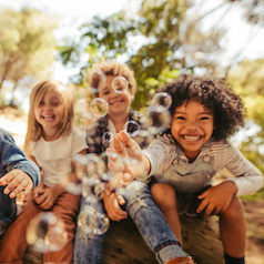 Group of children playing with soap bubbles