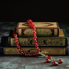 Zakat concept: Quran and tasbih with jar full of coins