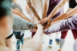 Group of diverse people stacking hands in the middle