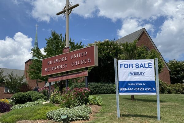 Photo of Biltmore UMC with a sign in front that reads "For Sale; Wesley CDC"