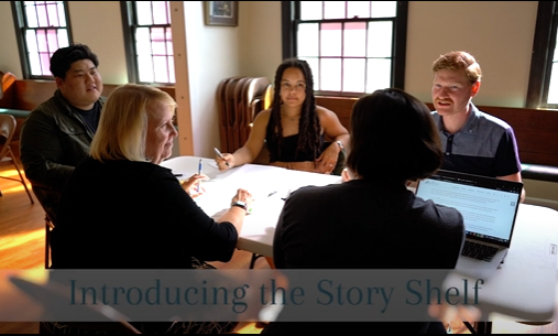 Photo of people having a discussion around a table with the title: Introducing the Story Shelf.