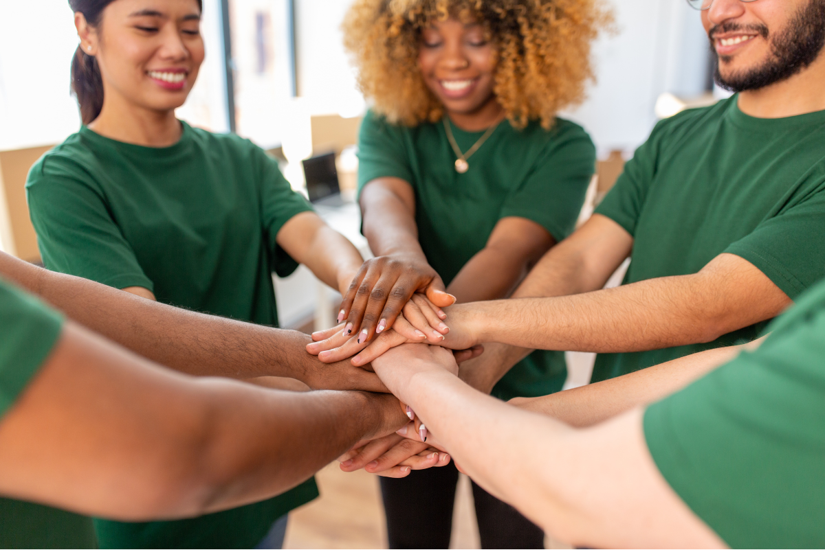 Volunteer hands together in the middle