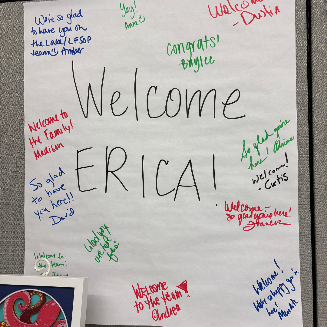 Whiteboard with notes welcoming Erica to the team
