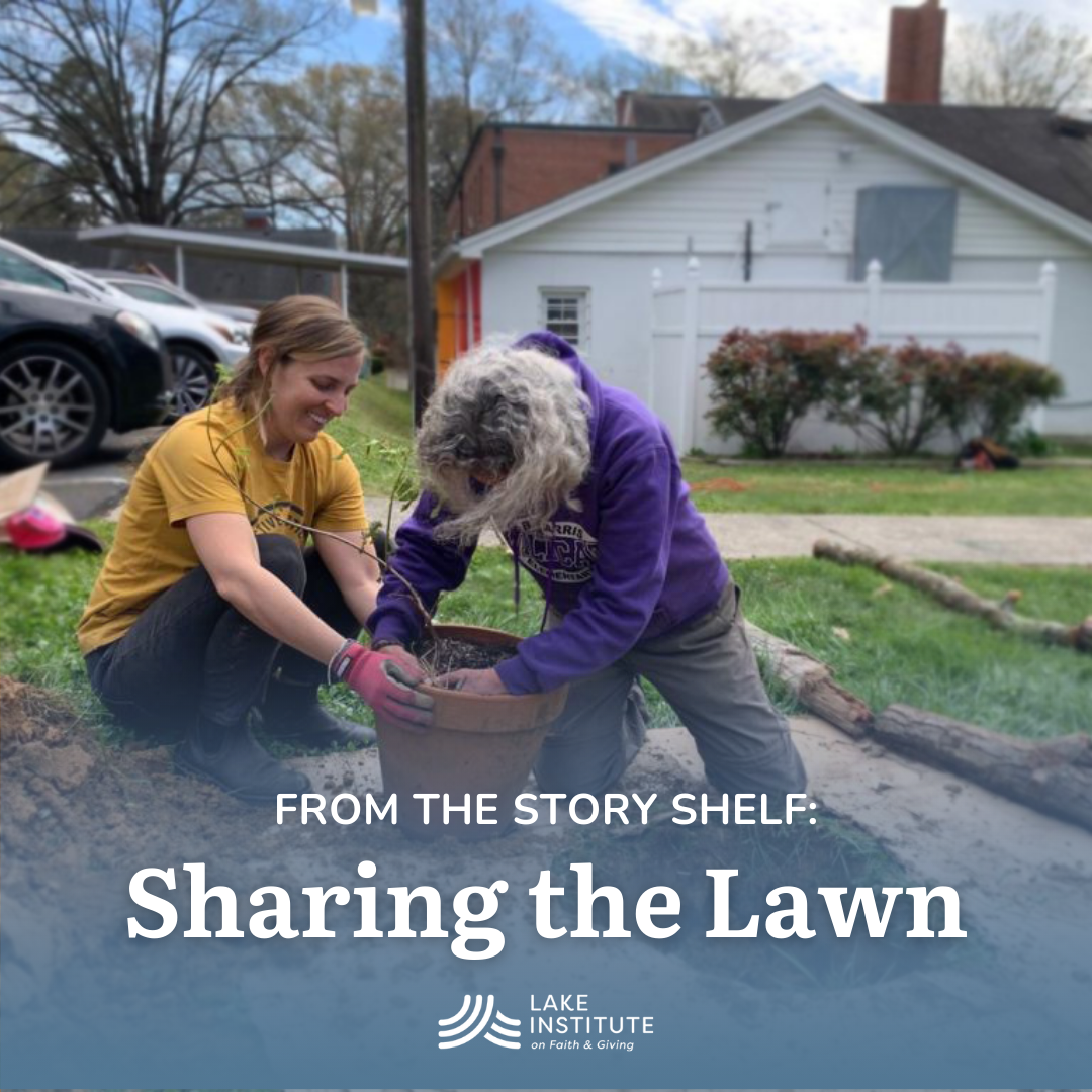 Two people kneeling on the ground planting a tree