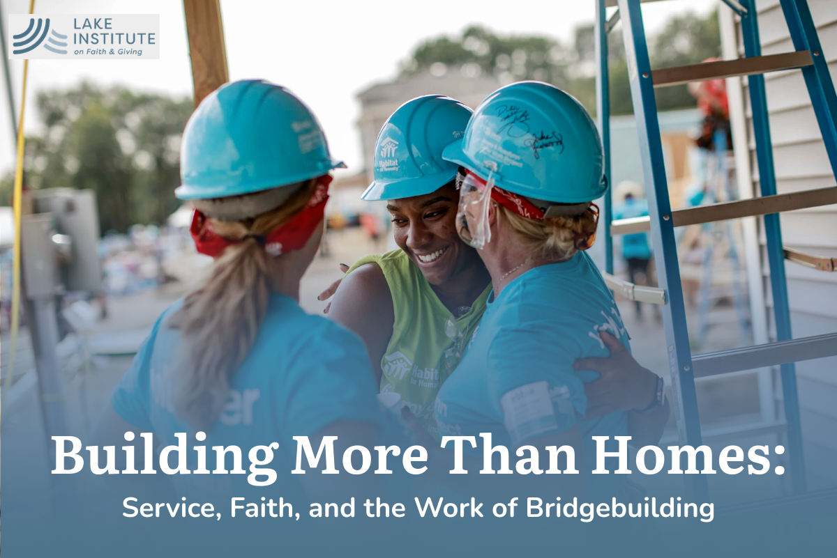 Three Habitat for Humanity workers hugging with hard hat ons