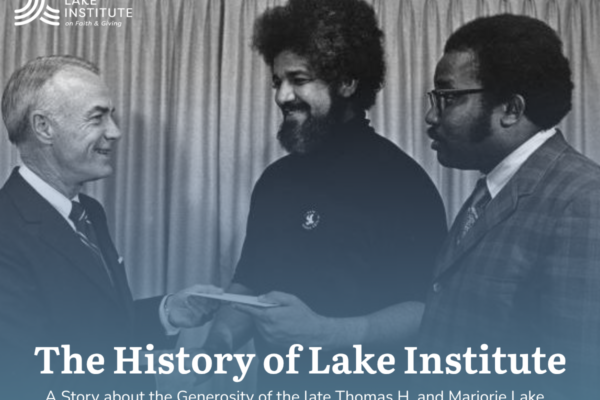Thomas H. Lake (left), presents a donation to Father Boniface Hardin (center).