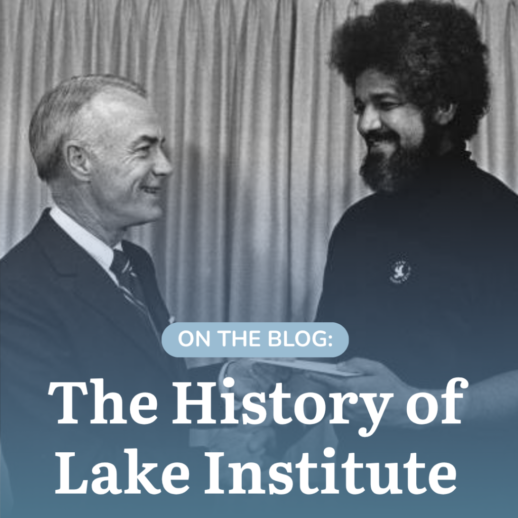 Thomas H. Lake (left), presents a donation to Father Boniface Hardin (right)